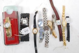 A large collection of women's watches to include a Swatch Irony Lady, Ingersoll, Rotary, Armani,