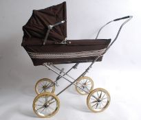 A vintage Silvercross brown childs pram with original hood, mat and wheels etc.