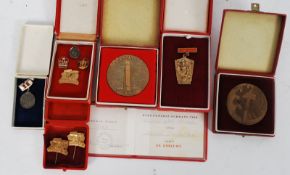 A good collection of Russian military ? / Industrial ? enamel badges and large commemorative plaques