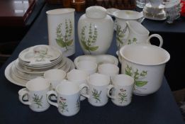 A Poole Pottery service comprising many items including cups, saucers, plates, storage jars etc