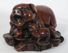 An Asian / Oriental resin pig and piglets