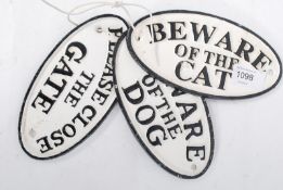 Three 20th century cast iron oval wall signs