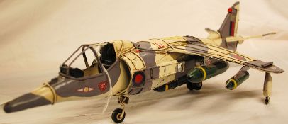 A 20th century scratchbuilt model of a harrier jump jet, with hand painted features.