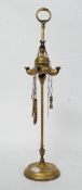 A 19th century brass candle holder with swan handles and attached scissors etc.