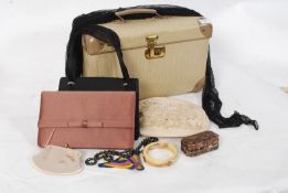 A 1950's vanity case containing evening bags, hats etc
