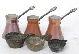 A set of 3 copper measures together with a copper taste de vin
