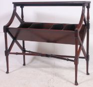 An Edwardian mahogany book trough. The moulded top over five angular divisions being raised on