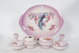 An Edwardian blush pink floral pattern dressing table set comprising of tray, trinket pots etc.