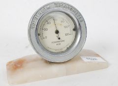 A post war Art Deco Coronation Rototherm Thermometer having chrome surround being mounted on a rouge