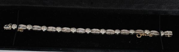 An 18ct white gold hallmarked 750 diamond set bracelet. Consisting of 11 claw set clusters each with