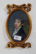 An antique style gilt framed printed portrait miniature of a young gentleman.