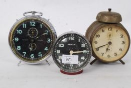 A collection of alarm clocks to include a Westclox and two others.