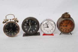A collection of alarm clocks to include a Sturm clock, Westclox and two others.