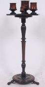 A decorative 20th century ebonised Victorian mahogany tripod smokers stand complete with the inset