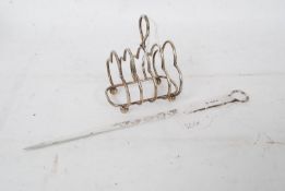 A silver hallmarked meat skewer bearing 1905 Birmingham hallmarks together with a silver toast