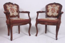 A pair of 20th century French fauteils armchairs with shaped legs have embroidered  tapestry foliate
