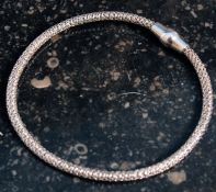 A silver bangle with magnetic clasp