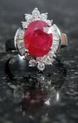 A silver CZ and faux ruby ring