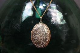 9ct gold large engraved locket on chain.