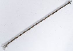 A silver bracelet set with square and ob