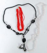 A rose quartz necklace and two others