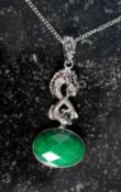 A silver and jade pendant set with drago