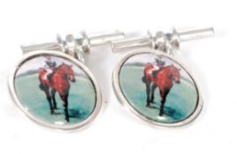 A pair of silver and enamel cufflinks de