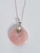 A silver and rose quartz necklace