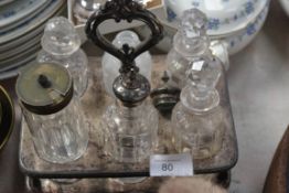 A glass condiments set with a white metal carrier