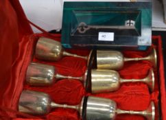 A six cup chalice set boxed along with a commemorative key in glass brick