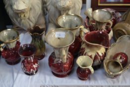 A collection of red and white china jugs with gilt