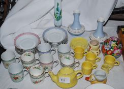 A collection of small cups and saucers with vases