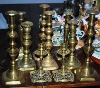A collection of brass candlestick pairs