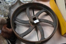 An antique industrial pulley wheel