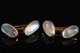 A pair of moonstone cuff-links: each wit