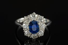 A platinum, sapphire and diamond oval cl