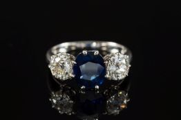 A sapphire and diamond three-stone ring: