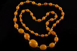 An amber, glass and composition bead sin