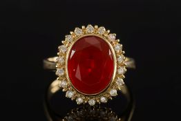 An 18ct gold, fire opal and diamond oval