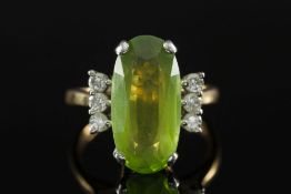 An 18ct gold, oval peridot and diamond r