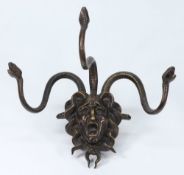 A bronze wall mounted coat hanger: in th