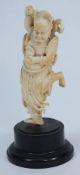 A Japanese carved ivory okimono of an on