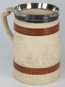 A Turner white stoneware mug: moulded wi