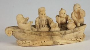 A Japanese ivory netsuke of four men in