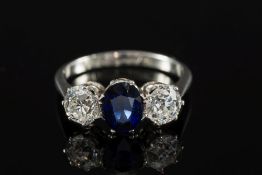 A sapphire and diamond three-stone ring: