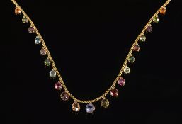 An early 20th century gold and multi-gem