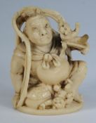 A Japanese carved ivory netsuke depictin