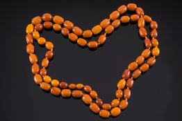 A long graduated amber bead single strin