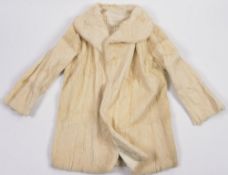 A vintage white fur half length coat:.