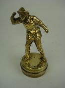A brass lifeboat-man mascot on radiator
